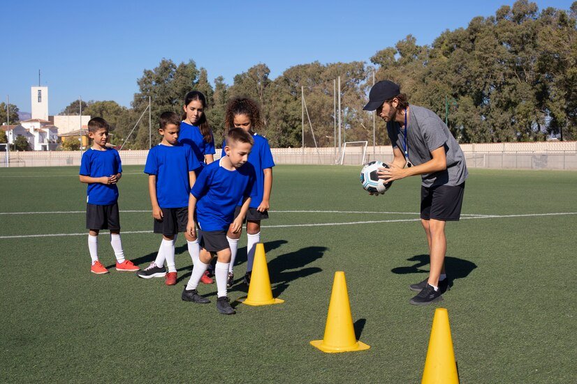 man-training-kids-playing-football-full-shot